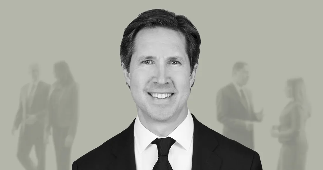 Black and white team headshot over a faded office
